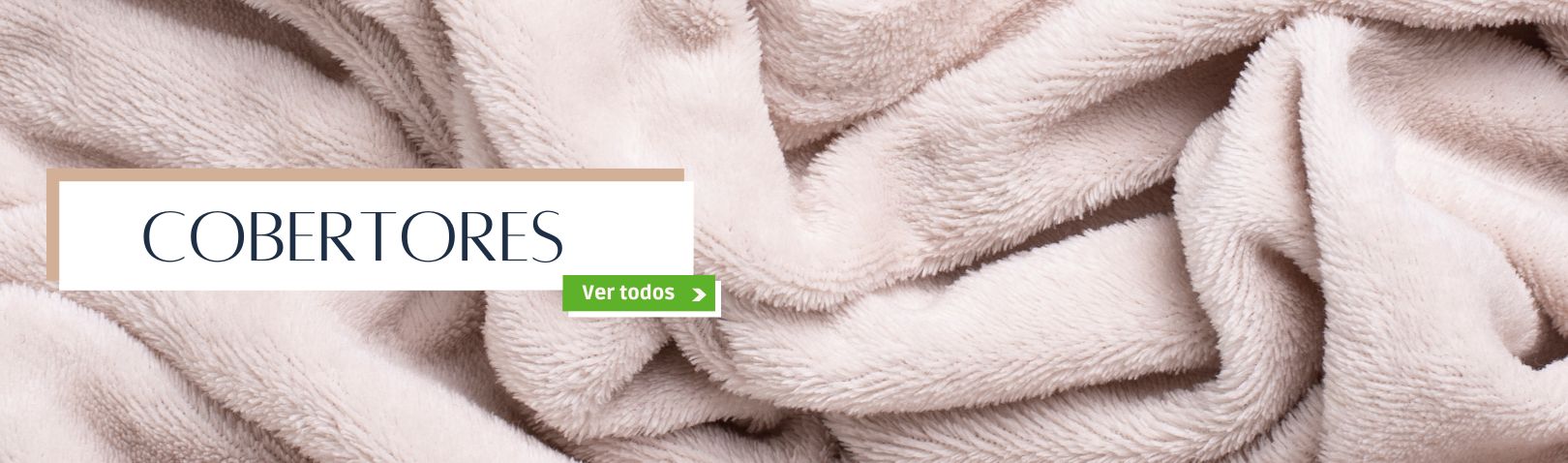  Close-up de um cobertor bege macio e felpudo, com o título "COBERTORES". O botão "Ver todos" leva à página com todos os tipos de cobertores, ideais para aquecer e decorar.